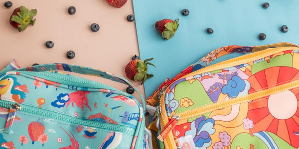 Bright Ellie Whittaker prints on insulated lunch bags with a front zipper pocket, top clip-off handle and shoulder strap